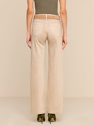 Model wearing the Scottie Coated Wide-Leg Jean in beige, paired with an olive green top and green heels, shown from the back against a neutral background.
