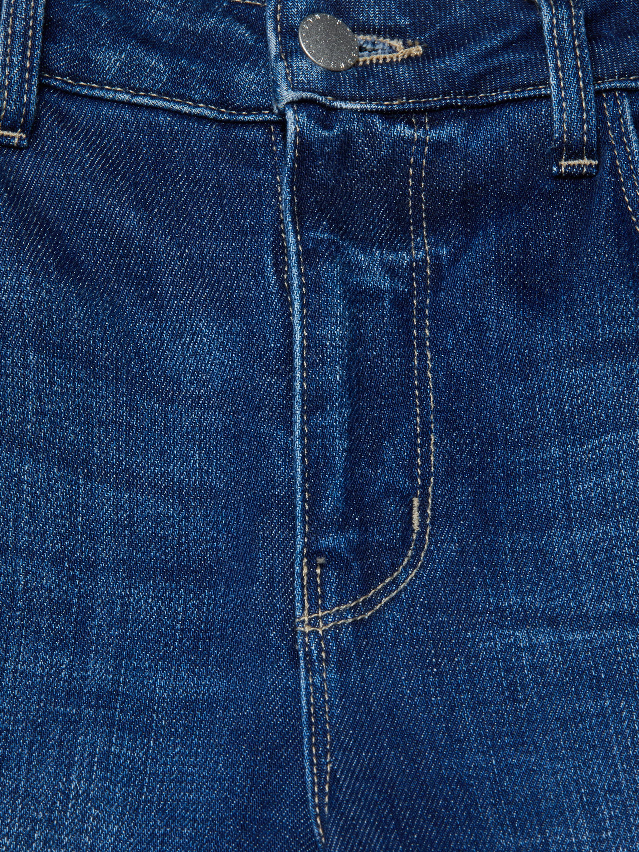 Close-up of the front of the Scottie Wide-Leg Jean in blue stretch denim, highlighting the contoured waistband, button, belt loops, zipper area, and part of the front pocket with visible stitching.
