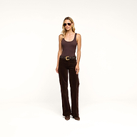A woman in sunglasses wears a brown tank top and the Scottie Velvet Wide-Leg Jean with a contoured waistband, paired with brown shoes, standing against a plain white background.