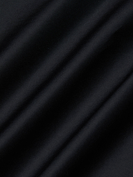 Close-up of the Lowen Pant’s black poplin fabric, featuring diagonal, soft shadows and a subtle texture that creates a striped pattern across the surface.