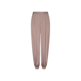 Palmer Satin Pant in taupe, featuring a high-rise, loose-fit silhouette with front pleats and gathered elastic cuffs at the ankles, displayed against a plain white background.