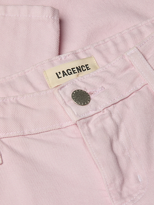 Close-up of pastel lilac Blaine Cropped Stovepipe Jean showing a metallic button and fabric label with LAGENCE near the waistband, highlighting this low-rise, cropped stovepipe style.