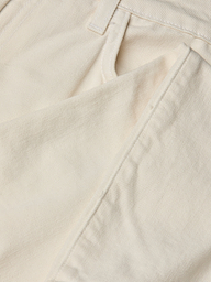 Close-up of the front pocket and waistband of the Blaine Cropped Stovepipe Jean in cream-colored all-cotton denim, highlighting the fabric’s texture, precise stitching, and part of a belt loop.
