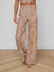 Model showcases the Livvy Lace Trouser, featuring a high-waisted, wide-leg silhouette in beige floral lace. Only her lower body is visible against a plain light background.