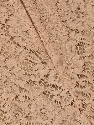 Close-up of Livvy Lace Trouser's cappuccino lace fabric, featuring an intricate floral pattern and diagonal seam—perfect for crafting elegant high-rise, straight-leg trousers.
