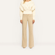 Joanne Low-Rise Wide-Leg Jean in a tan wash paired with a cream cable-knit sweater.