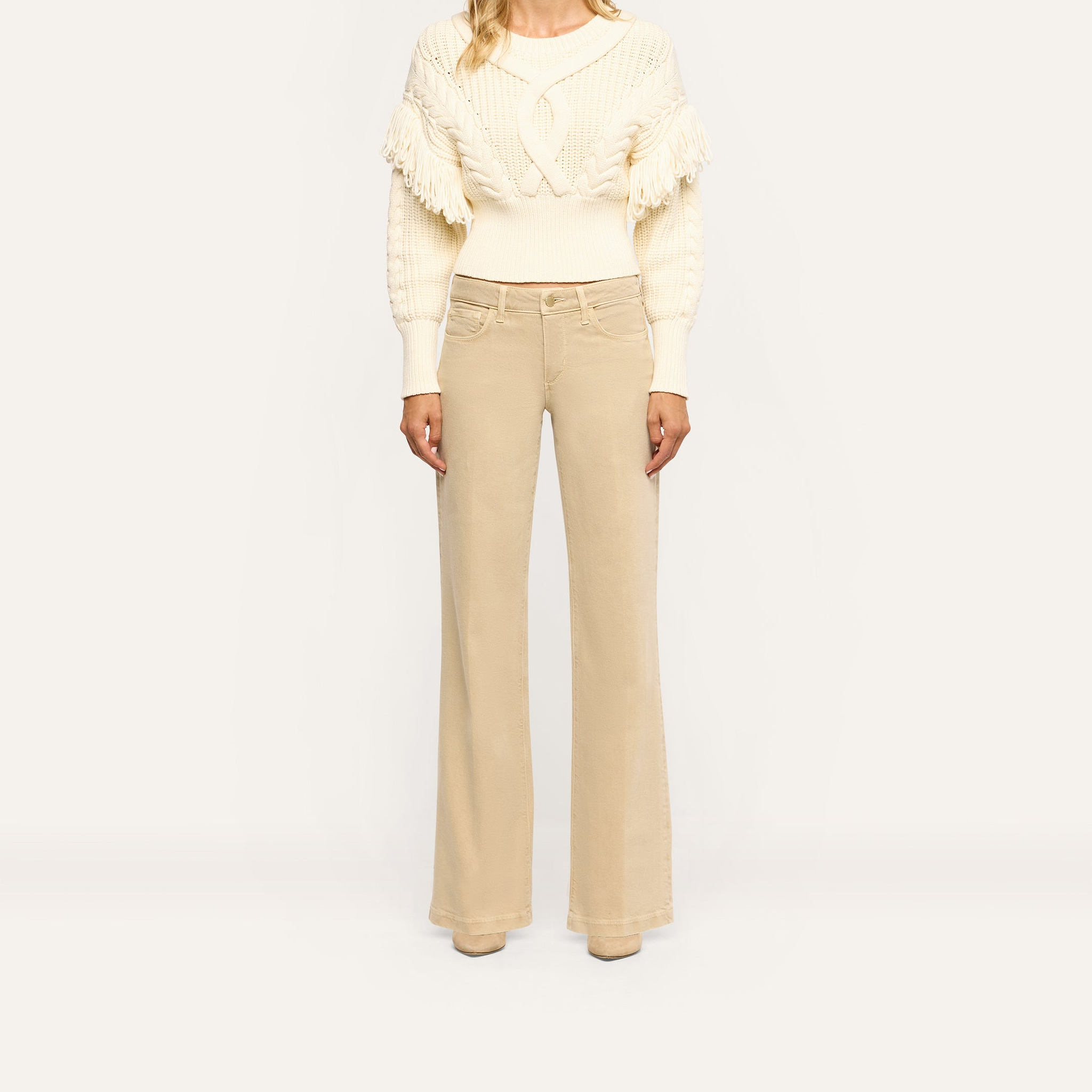 Joanne Low-Rise Wide-Leg Jean in a tan wash paired with a cream cable-knit sweater.