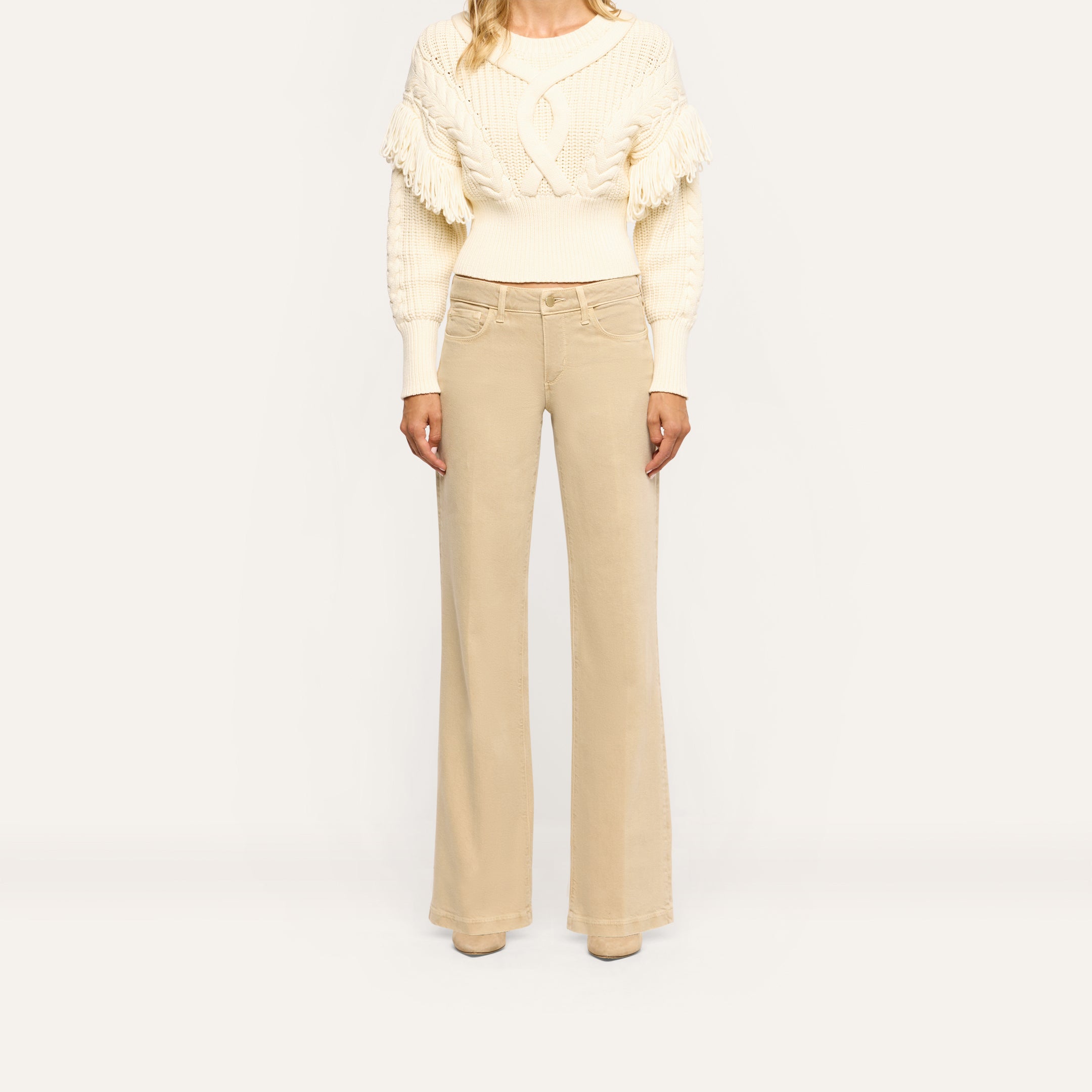 Joanne Low-Rise Wide-Leg Jean in a tan wash paired with a cream cable-knit sweater.