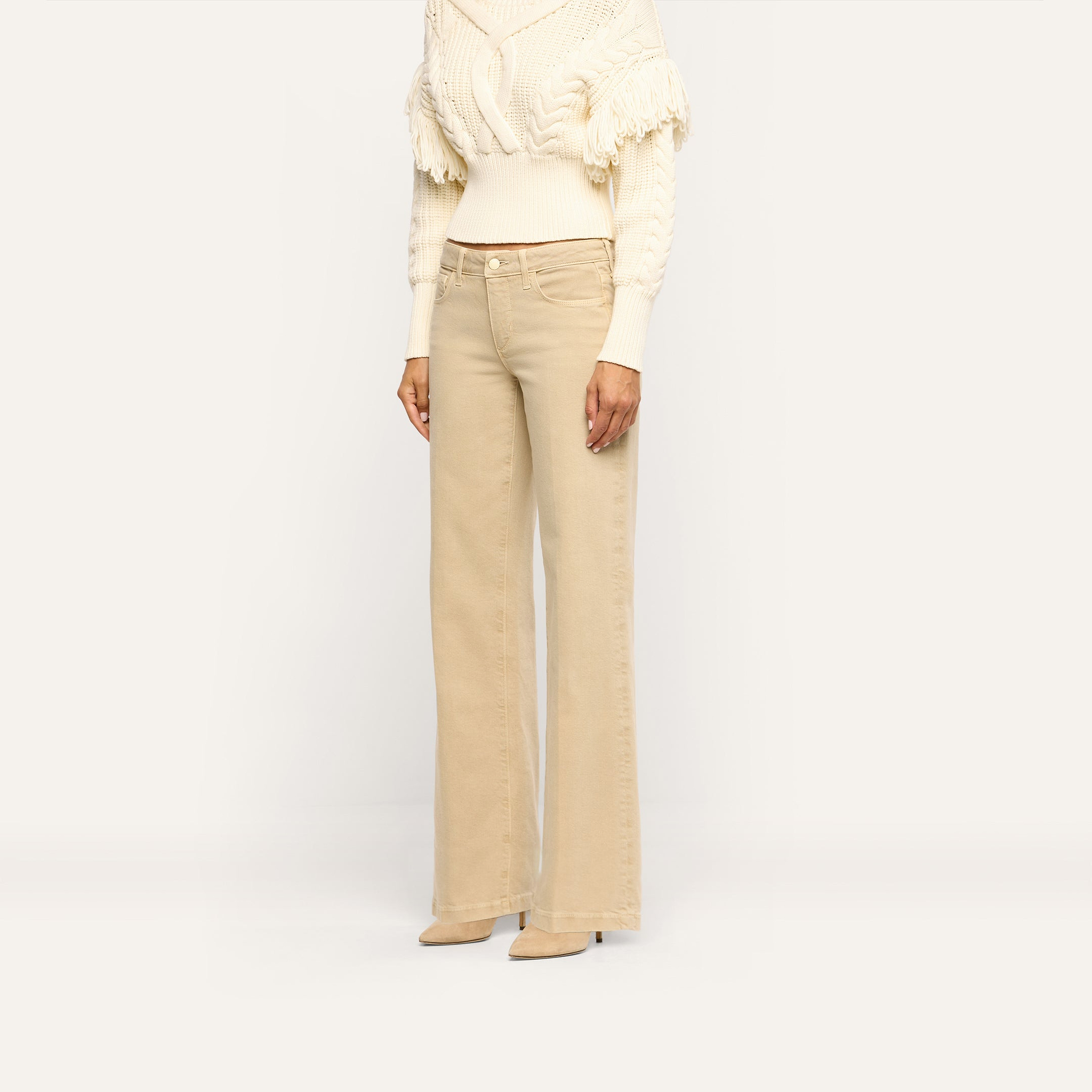 Beige Joanne Low-Rise Wide-Leg Jean paired with a cream cable-knit sweater and beige pointed-toe heels.