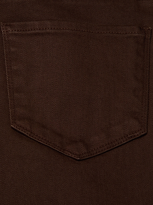 A close-up of the brown fabric pocket on the Joanne Low-Rise Wide-Leg Jean by L'AGENCE shows visible stitching, a slightly pointed bottom, and clear material texture.