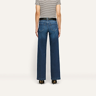 Back view of Joanne Low-Rise Wide-Leg Jean in stretch denim, featuring a black belt, striped t-shirt, and black heels.