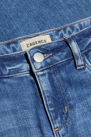 Close-up of the Joanne Low-Rise Wide-Leg Jean in blue stretch denim, featuring a silver button, orange stitching, and a LAGENCE label sewn onto the waistband.