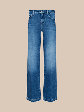 Joanne Low-Rise Wide-Leg Jean in blue stretch denim features a faded wash effect, a low-rise fit, front button and zipper closure, and classic five-pocket styling, shown against a beige background.