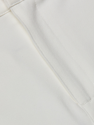 Close-up of the Ketra Bootcut Trouser in white stretch suit fabric, highlighting its neatly sewn welt pocket, detailed stitching, and textured finish.