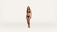 Woman standing and facing forward, wearing a black bikini, with a neutral expression and relaxed posture against a plain white background.