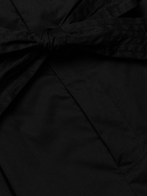 Close-up of a black fabric bow tied on the Damira Poplin Short, highlighting detailed stitching and smooth, matte stretch poplin material at the ultra-high waist.