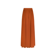 The Haylo Pant is displayed on a plain white background in a rich burnt orange hue, offering an effortlessly chic look similar to that of a long, flowy maxi skirt with a fitted waistband.