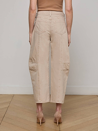 A person wearing the Cody Cropped Barrel-Leg Jean, featuring a beige wide-leg silhouette with patch pockets, paired with tan heels and shown from the back against a plain white background.