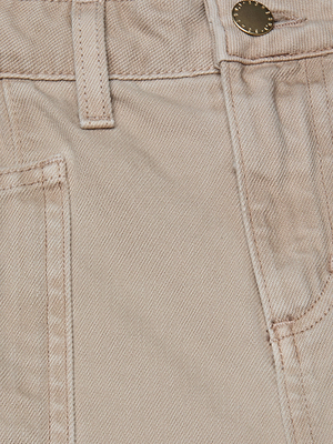 Close-up of the L'AGENCE Cody Cropped Barrel-Leg Jean in light beige all-cotton denim, featuring a waistband with belt loop, metal button, and part of the front pocket with visible stitching.