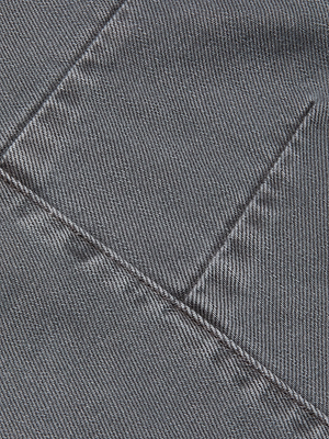 Close-up of gray all-cotton denim with a diagonal stitch and pocket edge, highlighting the texture—ideal for the Cody Cropped Barrel-Leg Jean.