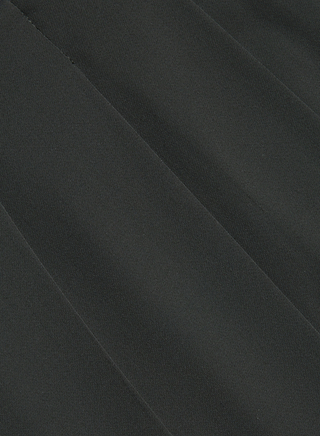 Close-up of dark gray fabric with diagonal seam lines creating a textured, folded appearance, reminiscent of the smooth, tightly woven material used in the Novalynn Cropped Pleated Pant.