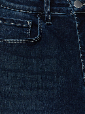 Close-up of the front of the L'AGENCE Cara Low-Rise Bootcut Jean in dark blue super stretch denim, featuring a pocket, belt loop, metal button, and visible white stitching.