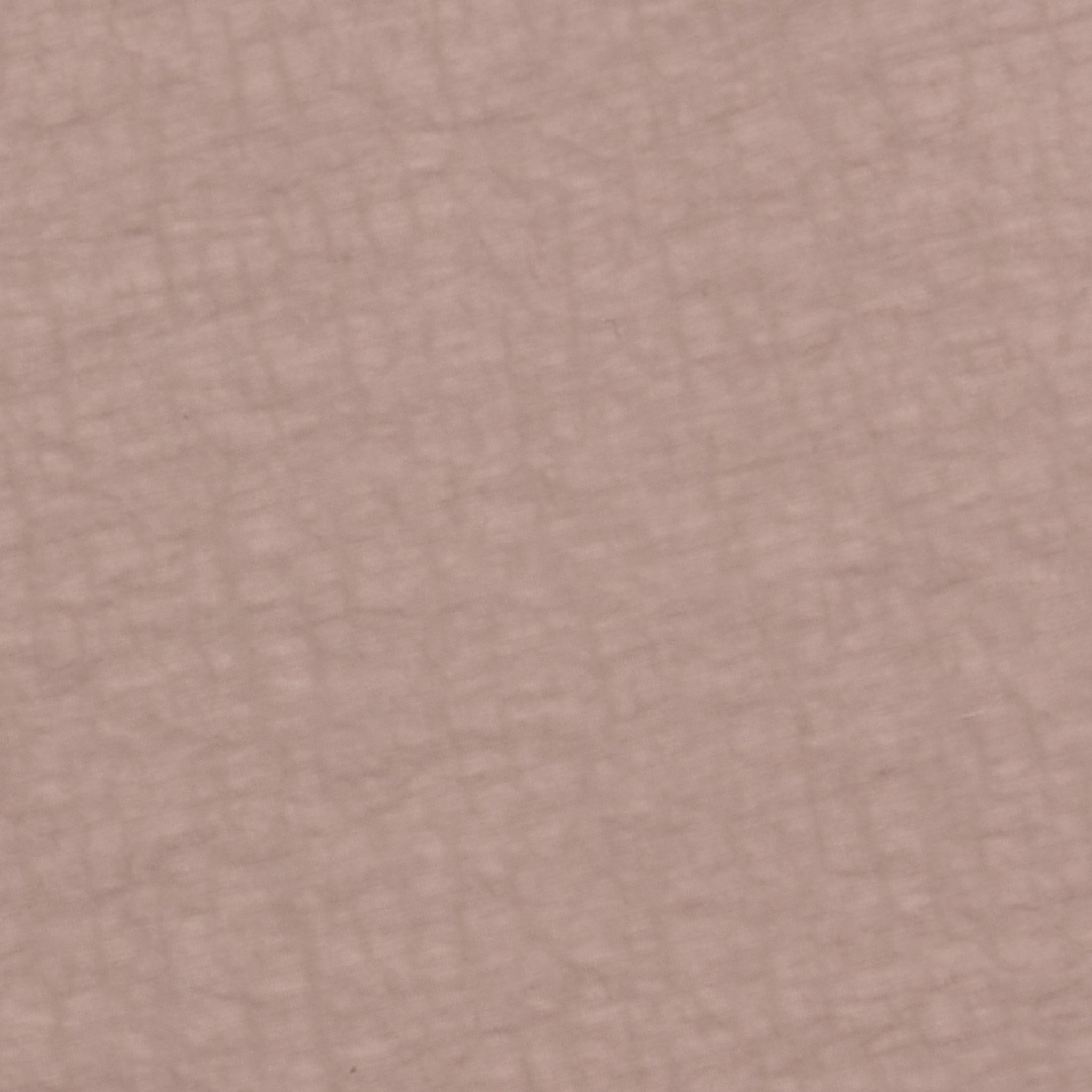 Close-up of the Mariko Jogger’s textured surface in muted pinkish-beige and light cardamom brown, featuring a subtle pattern of intersecting lines reminiscent of soft, crisscrossed fabric or water-repellent nylon.
