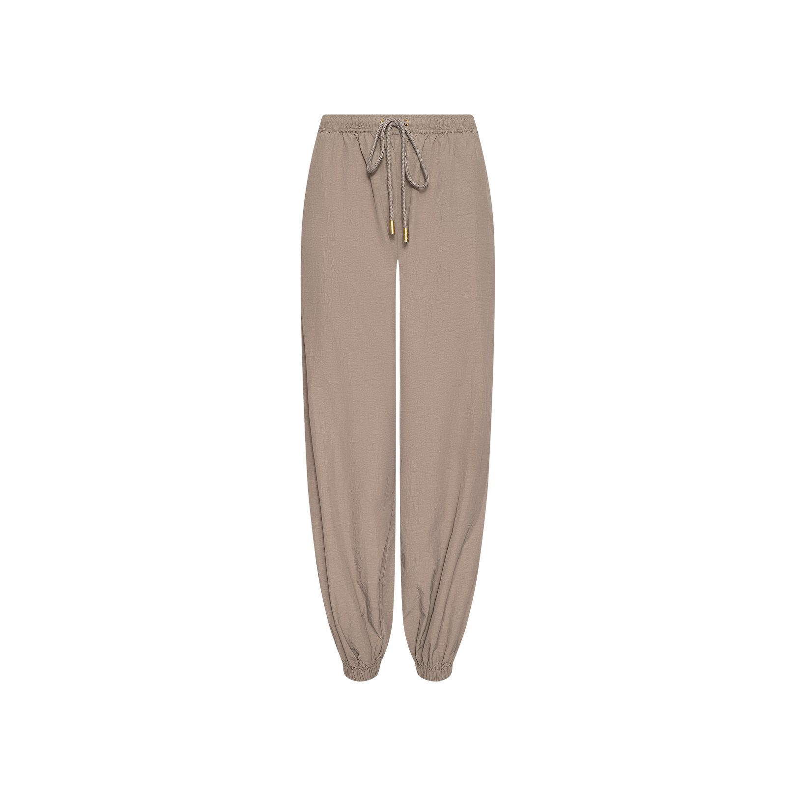 Mariko Jogger in light cardamom brown, crafted from water-repellent nylon, featuring an elastic waistband and cuffs with a front drawstring tie, displayed on a plain white background.