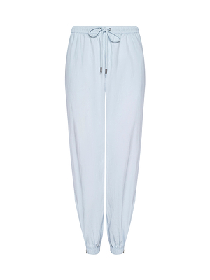 The Mariko Jogger is a light blue, lightweight water-repellent nylon pant with an elastic waistband, drawstring tie, and elastic ankle cuffs. Displayed on a white background, these joggers mix style with practical design.