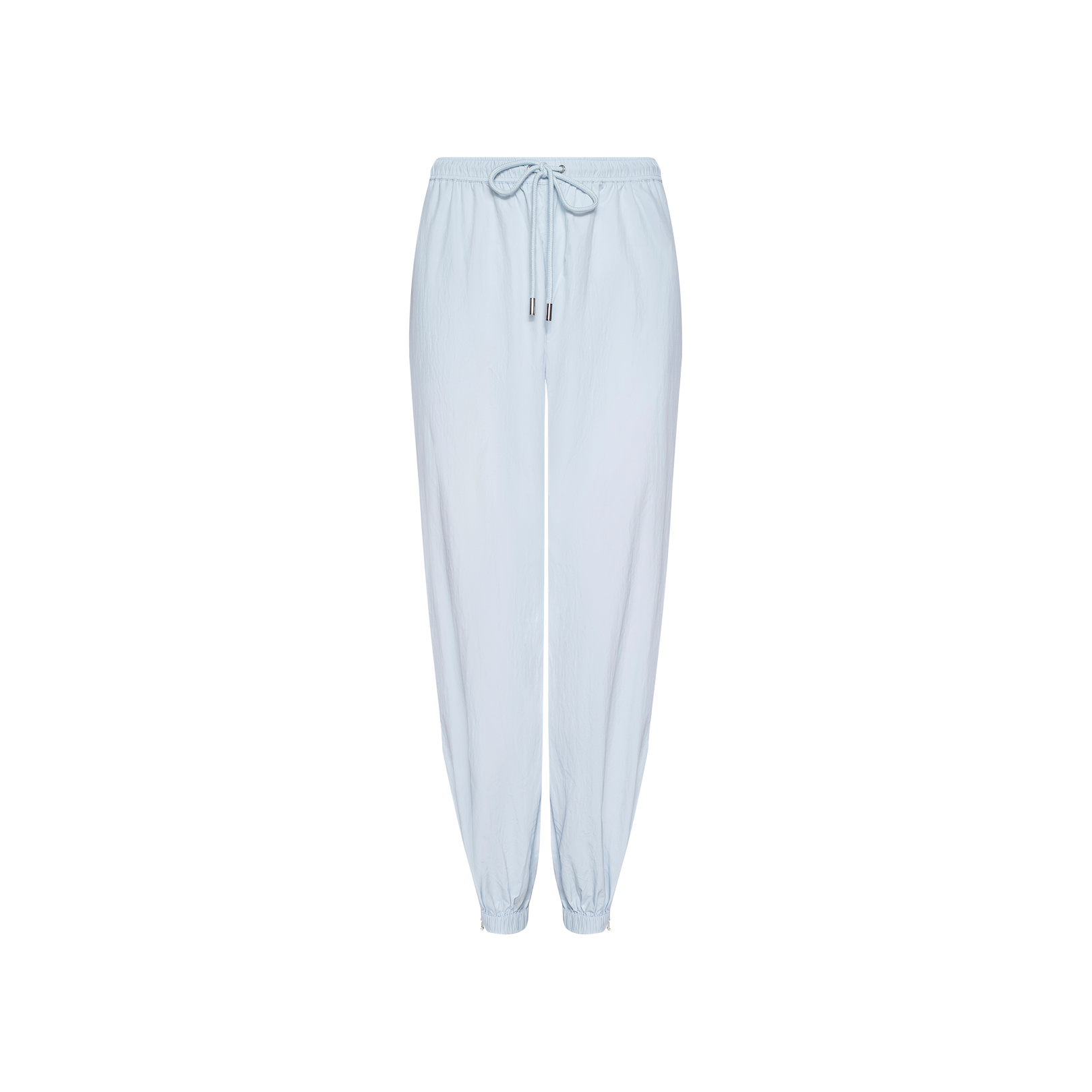 The Mariko Jogger, made from light blue lightweight nylon, features an elastic waistband with a drawstring tie and elastic cuffs at the ankles, shown against a white background.