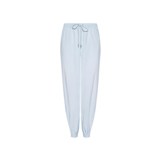 The Mariko Jogger, crafted from water-repellent nylon in a pale blue hue, features an elastic waistband with drawstring tie and elasticized cuffs, shown on a plain white background.