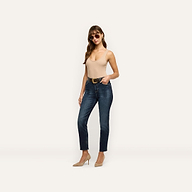 A woman wearing a beige tank top, sunglasses, a black belt, tan heels, and Celestia Slim-Leg Jean ultra high rise slim jeans.