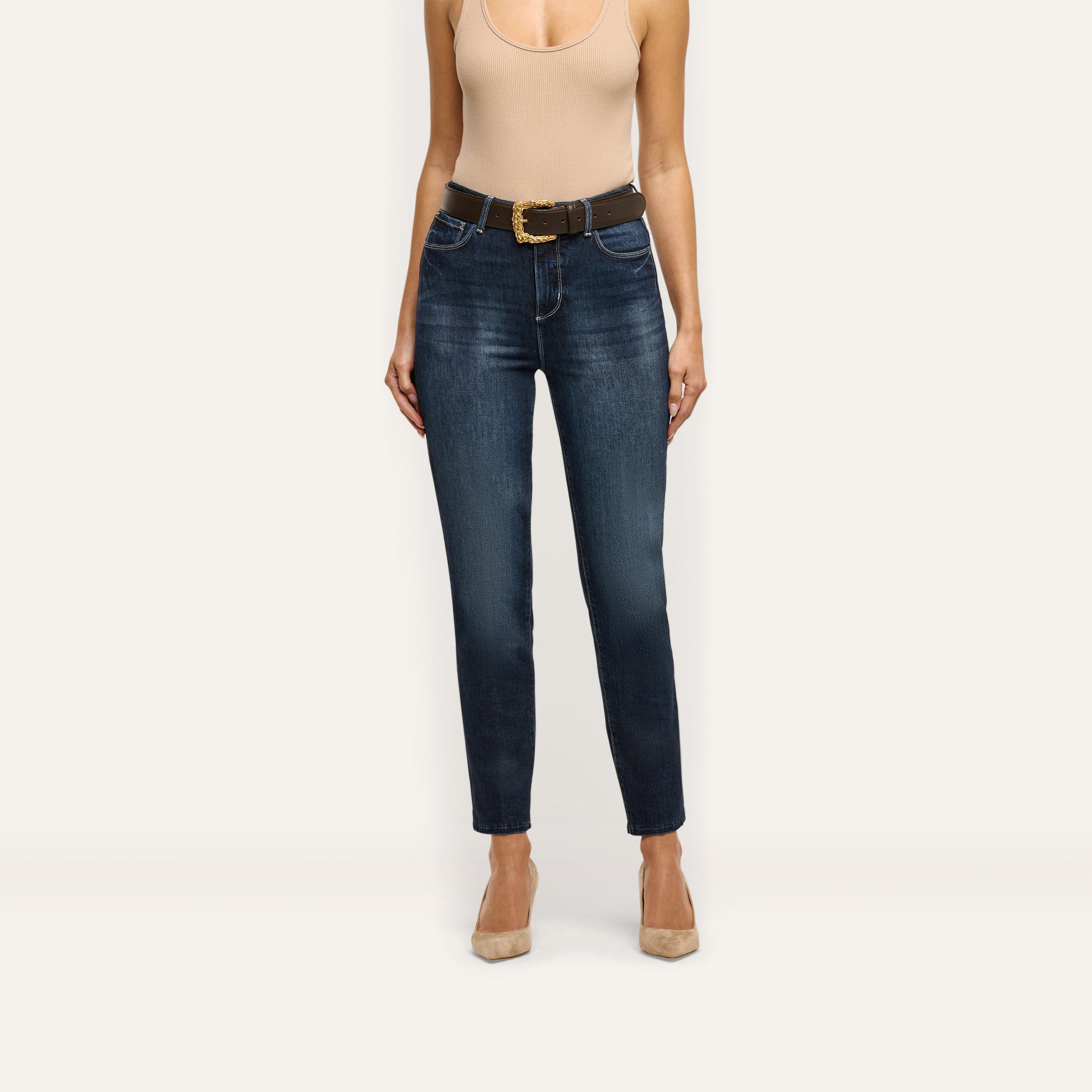 Celestia Slim-Leg Jean in a dark wash, ultra high rise, slim-leg fit, styled with a brown leather belt featuring a gold buckle.