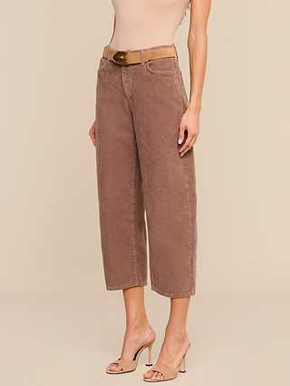 A person models the Mallis Corduroy Bow-Leg Pant in brown, paired with a tan belt, a beige sleeveless top, and beige high-heeled sandals against a neutral background. With the head out of frame, the look feels effortless—perfect for elevating any casual wardrobe.