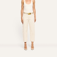 Mallis Corduroy Bow-Leg Pant in cream, featuring a high-rise, relaxed wide-leg silhouette styled with a textured belt with a gold buckle and pointed-toe heels.