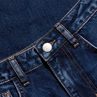 Close-up of dark blue denim jeans showcasing the waistband, belt loops, metal button, and distinctive orange stitching details.