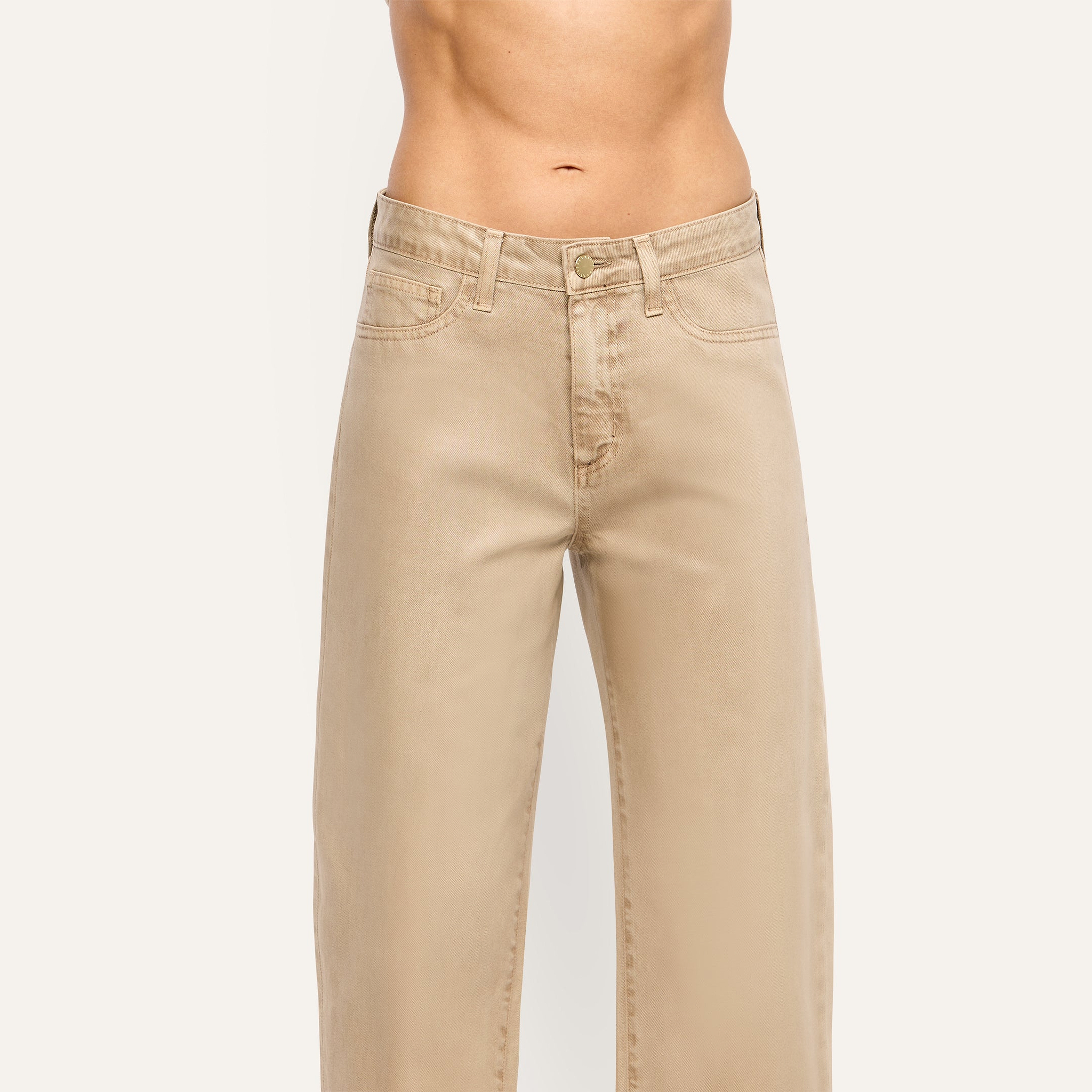 Mallis Coated Bow-Leg Jean in beige featuring a high-rise, wide-leg, curved silhouette in coated denim.