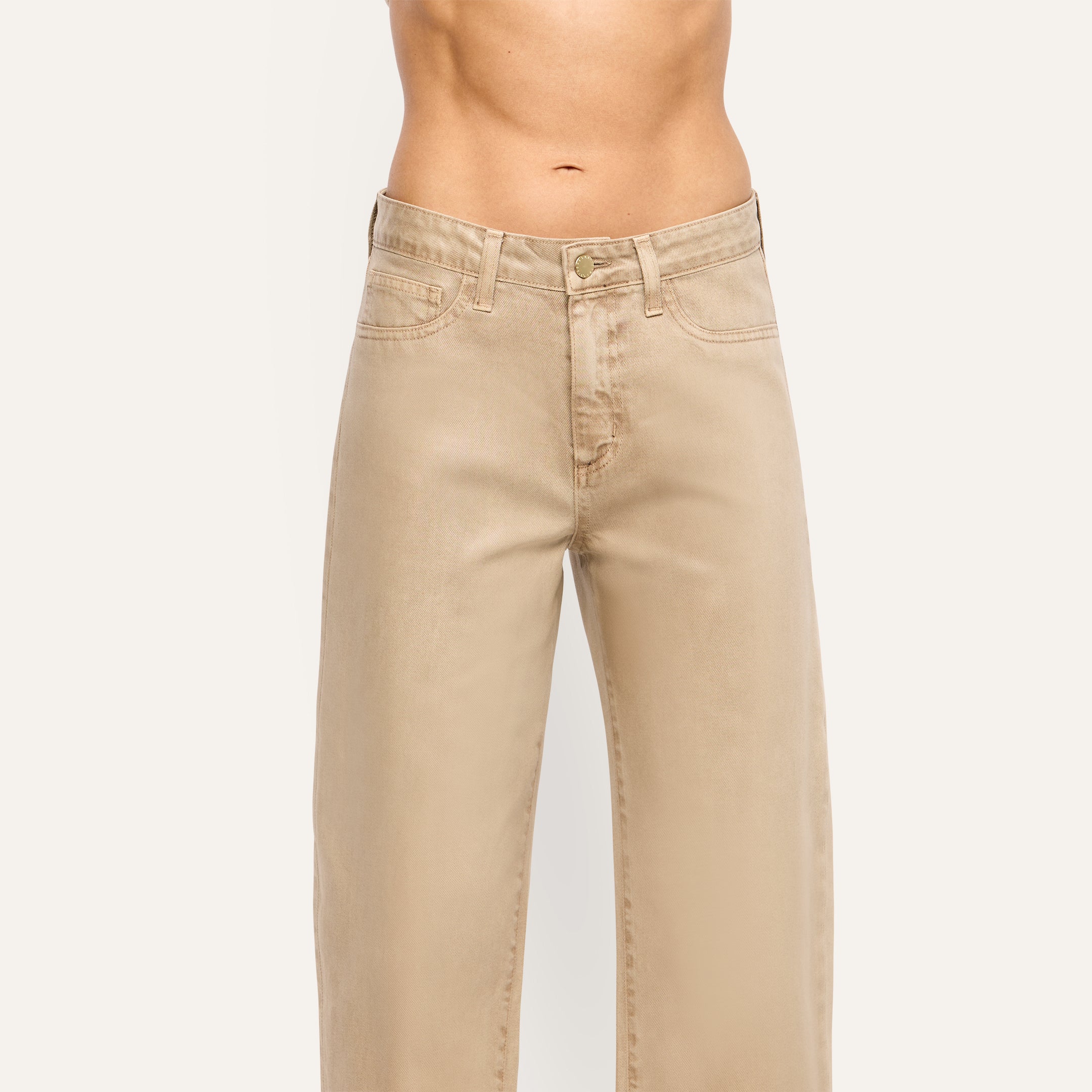 Mallis Coated Bow-Leg Jean in beige featuring a high-rise, wide-leg, curved silhouette in coated denim.