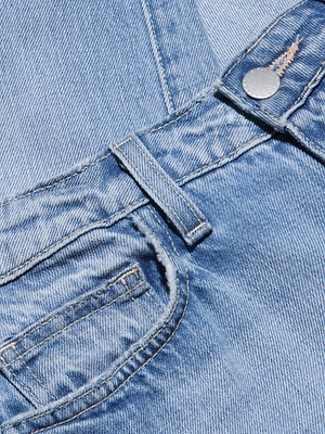 Close-up of the Ashby Low-Rise Slouch Jean in light blue, all-cotton denim, showcasing the front pocket, belt loop, metal button, and stitching details.