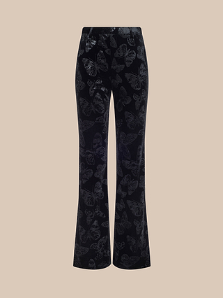 Frances Bootcut Trouser in black velvet, featuring a subtle butterfly print and a bootcut silhouette, displayed against a plain beige background.