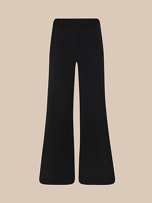 The Chelsy Wide-Leg Pant is a black, high-waisted style featuring fluid tailoring and a slight flare, shown against a beige background.
