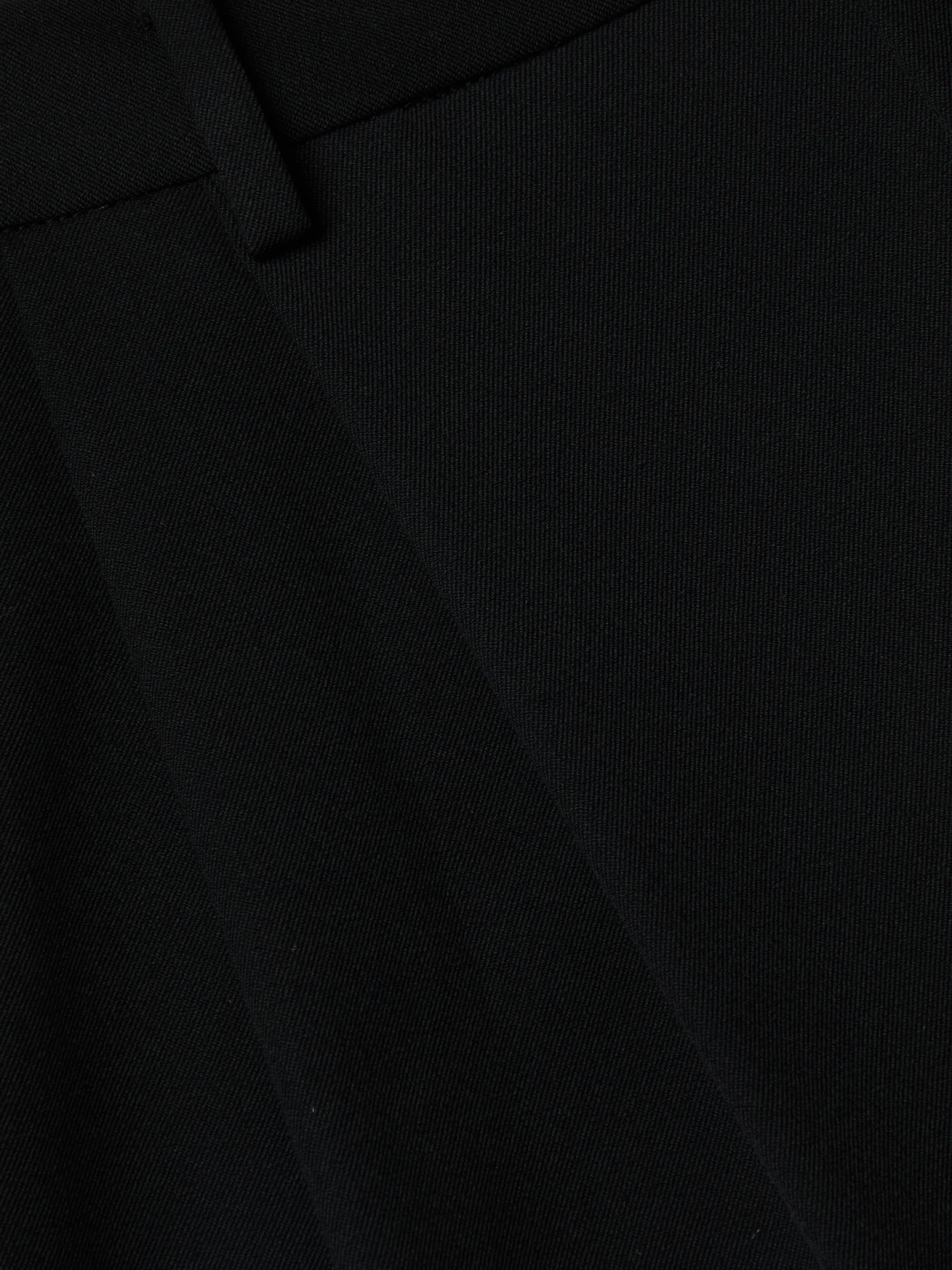 Close-up of the Chelsy Wide-Leg Pant in black textured fabric, showcasing its visible seam and waistband.