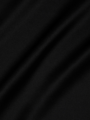 Smooth black silk charmeuse with subtle folds creates a play of light and shadow—perfectly showcased in the elegant Perin Silk Midi Skirt.