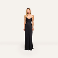 A woman with long blonde hair and a neutral expression stands against a plain background wearing the Zeta Satin Maxi Skirt.