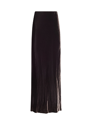 The Zeta Velvet Maxi Skirt features a long, black velvet design with a straight, slightly flared silhouette inspired by historical romance and elegance, displayed against a white background.