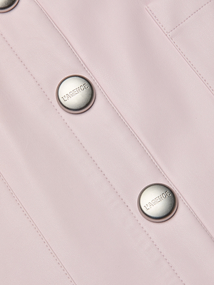 Close-up of the Truman Vegan Leather Mini Skirt in icy lilac, featuring silver round LAGENCE-engraved buttons and vertical stitching.
