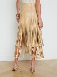 A person wearing the Karolina Fringe Skirt and high-heeled shoes is standing with their back toward the camera against a plain white background.