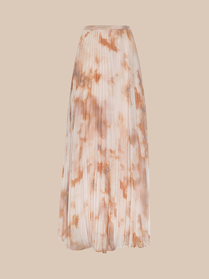 The Torin Pleated Maxi Skirt is crafted from airy poly chiffon, showcasing a soft beige base with an abstract, cloud-like light brown pattern against a plain beige background.