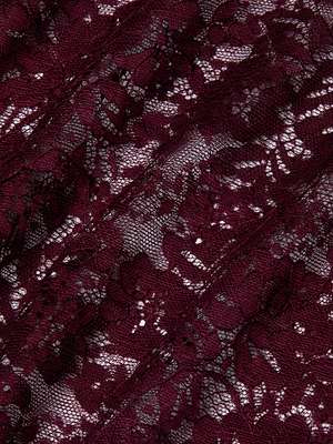 Close-up of the Makena Lace Pencil Skirt by L'AGENCE, showcasing sheer maroon floral lace with semi-transparent areas and intricate threadwork detailing.