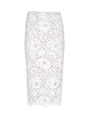 The Makena Sequin Pencil Skirt features white lace with a floral pattern and scalloped hem, capturing spring 2026 fashion trends. Displayed on a plain white background.